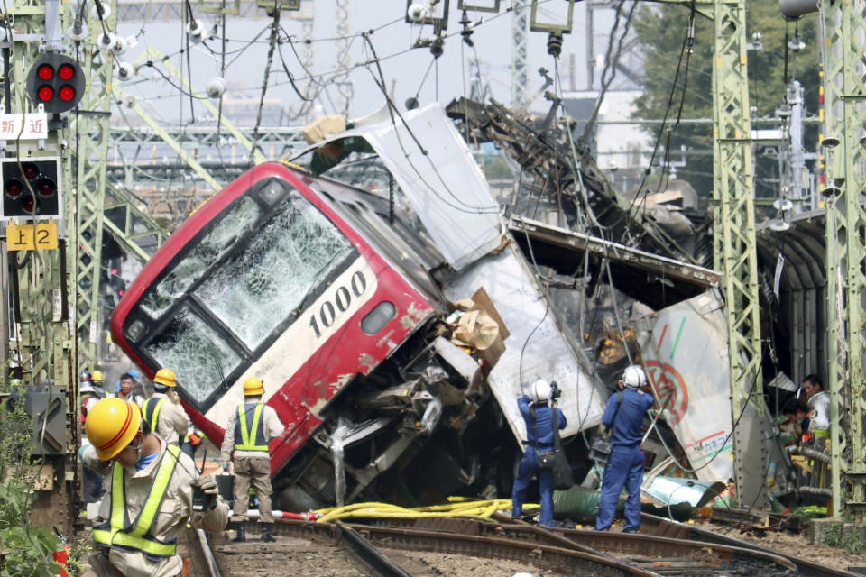 A train sits derailed after a collision with a truck in Yokohama, near Tokyo Thursday, Sept. 5, 2019. Police and fire department officials said the collision occurred late morning Thursday as the truck apparently entered a railway crossing in Yokohama. (Kyodo News via AP)