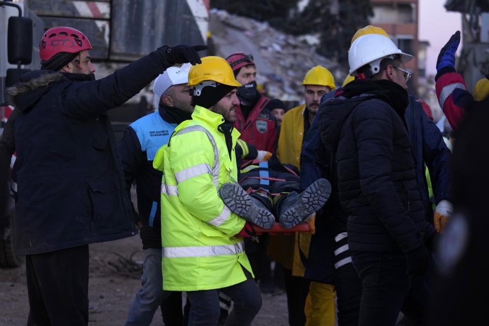 A rescue worker being taking out after had a fraction on his leg, in Ghaziantep, southeastern Turkey, Wednesday, Feb. 8, 2023. With the hope of finding survivors fading, stretched rescue teams in Turkey and Syria searched Wednesday for signs of life in the rubble of thousands of buildings toppled by a catastrophic earthquake. (AP Photo/Kamran Jebreili)