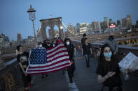 Protesters march across the Brooklyn Bridge as part of a solidarity rally calling for justice over the death of George Floyd Monday, June 1, 2020, in the Brooklyn borough of New York. Floyd died after being restrained by Minneapolis police officers on May 25. (AP Photo/Wong Maye-E)