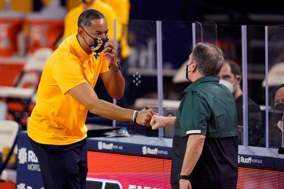 Michigan coach Juwan Howard, left, shakes hands with Michigan State coach Tom Izzo after the Wolverines' 69-50 win at Crisler Center in Ann Arbor, March 4, 2021.