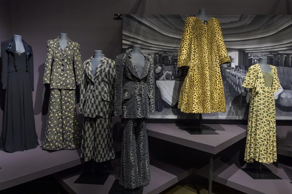 a group of dresses on display