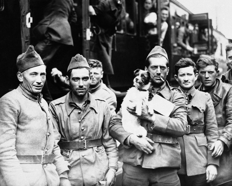 Thousands of troops poured into England during the night, after heroically fighting their way out of Northern France and Belgium. French troops with the dog they rescued, seen during a halt at a wayside station on June 24, 1940. A large number of dogs have been brought over by the gallant Allied soldiers.