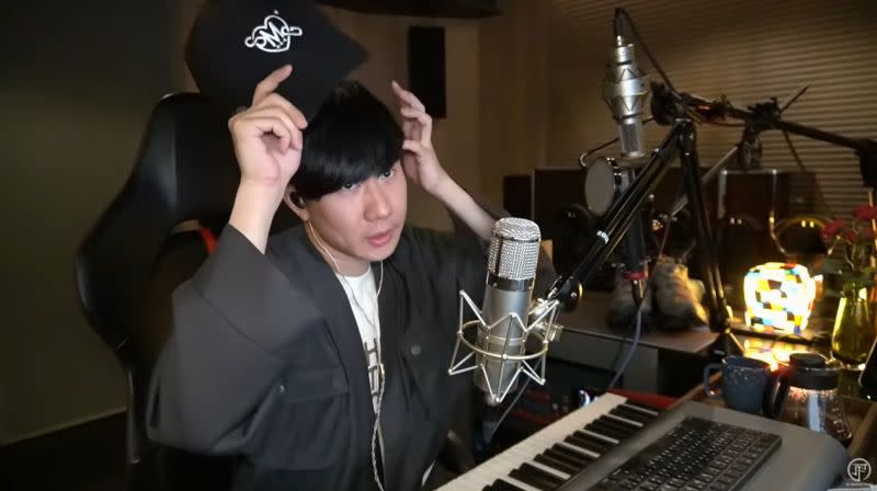JJ Lin is seen taking off his cap from time to time to style his bangs. (Screenshot from the video)