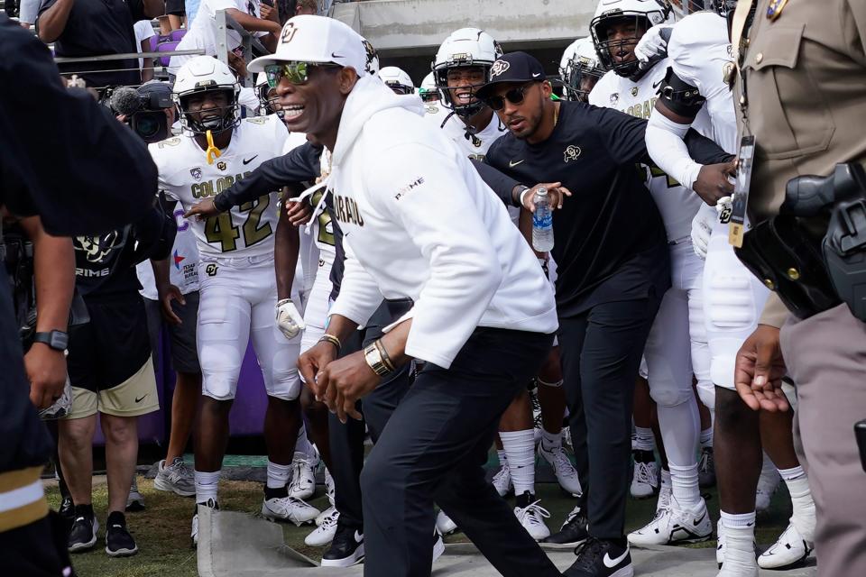 Colorado head coach Deion Sanders runs onto the field with his team for an NCAA college football game against TCU Saturday, Sept. 2, 2023, in Fort Worth, Texas. (AP Photo/LM Otero)