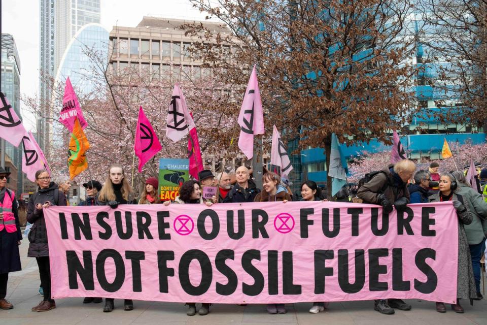 Protesters hold a sign outside the offices of Probitas in London in 2024 (Expatiate / Extinction Rebellion / PA)