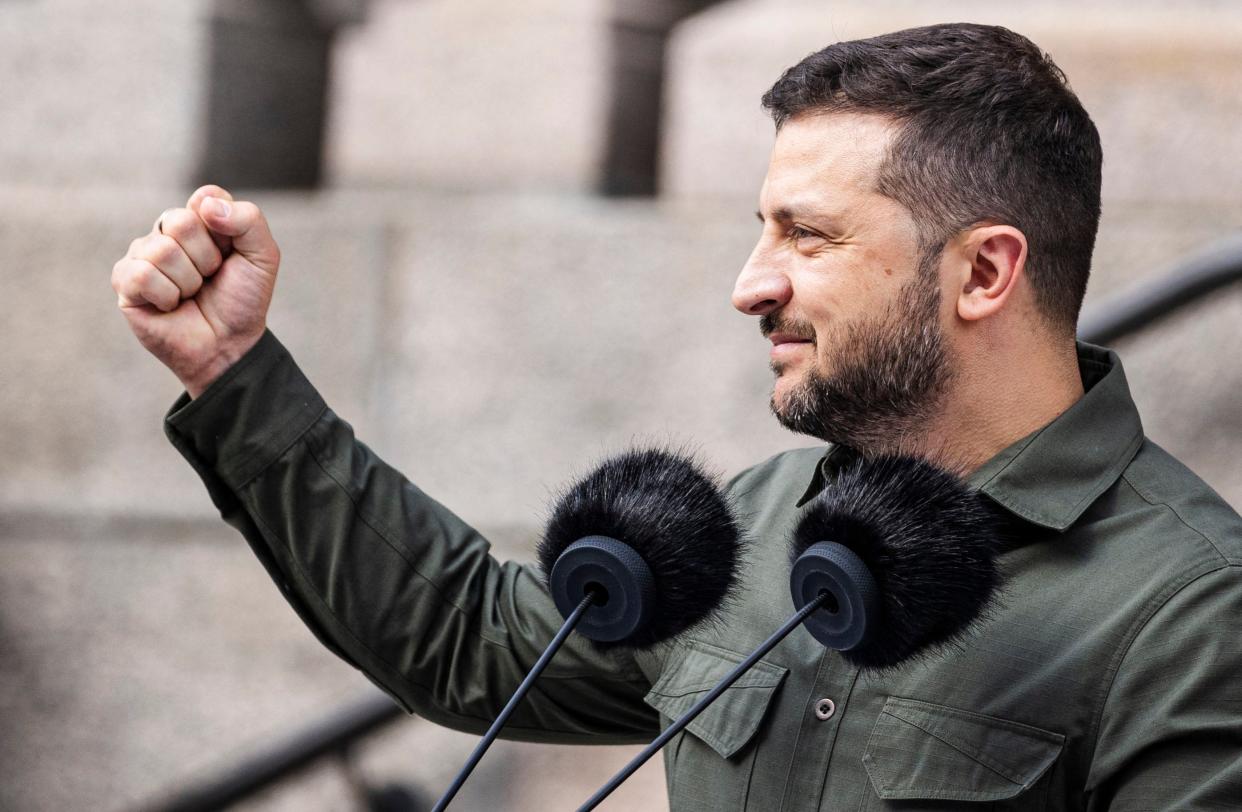 Ukrainian President Volodymyr Zelensky clenches his fist as he speaks to the crowd in front of the Danish Parliament in Copenhagen, Denmark, on 21 August 2023 (Ritzau Scanpix/AFP via Getty Ima)