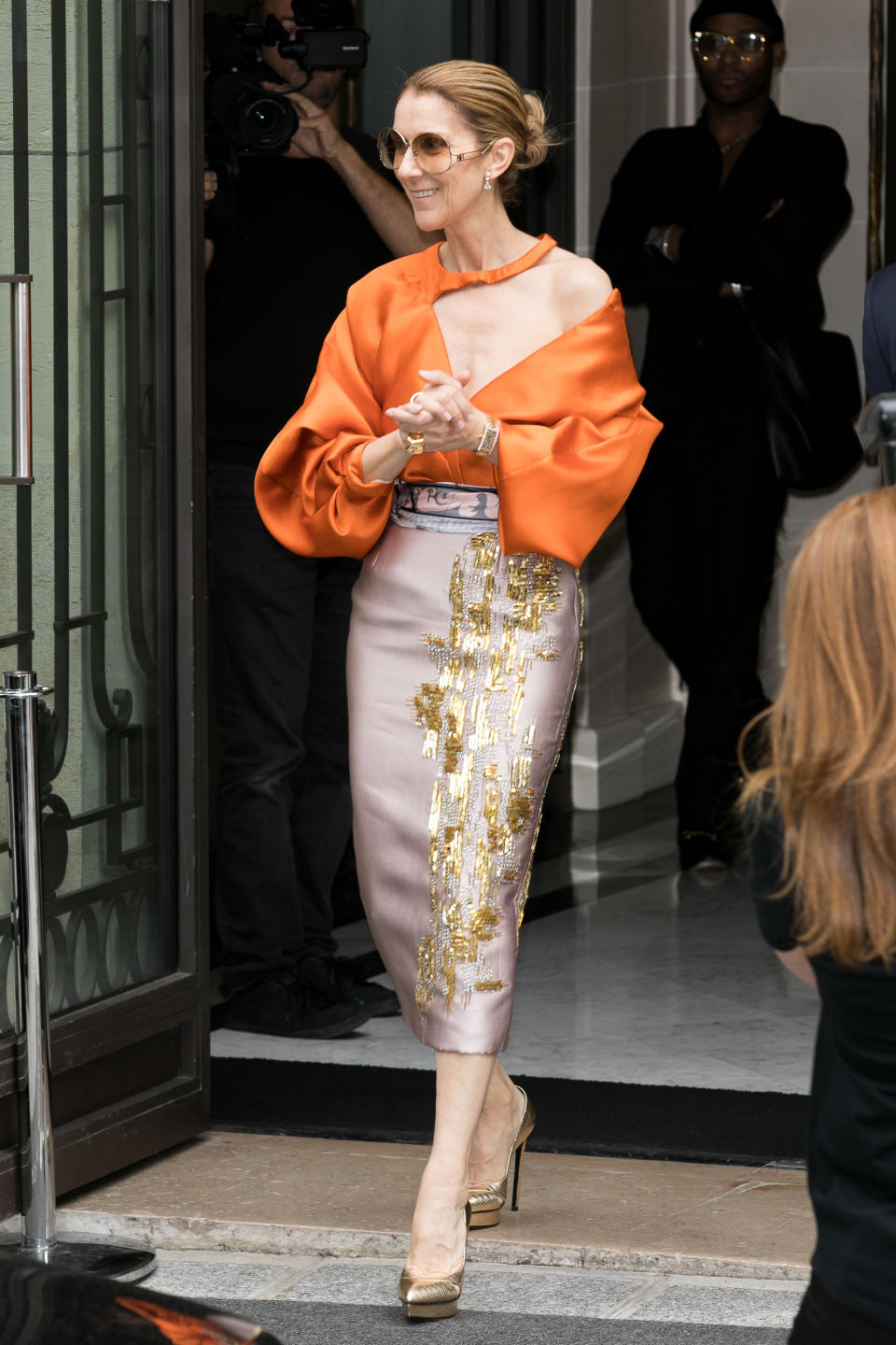 Knowing orange would be the ‘it’ hue before we ever could, the singer stepped out in an asymmetric blouse (complete with midi skirt) back in July 2017. [Photo: Getty]