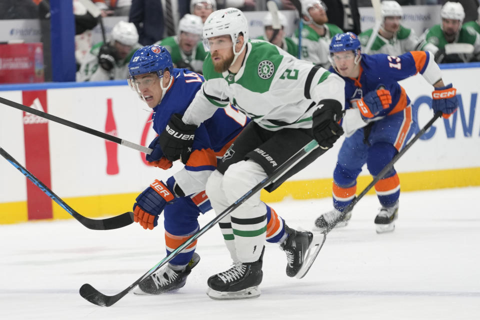 New York Islanders left wing Anders Lee skates against Dallas Stars defenseman Jani Hakanpaa (2) during the second period of an NHL hockey game, Sunday, Jan. 21, 2024, in Elmont, N.Y. (AP Photo/Mary Altaffer)