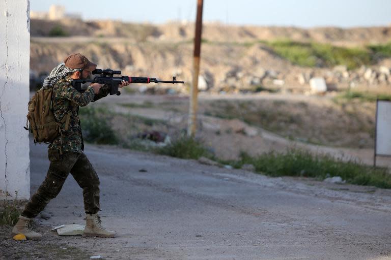 A member of the Popular Mobilisation unit monitors the city of Tikrit, Iraq, from his position in the village of Awja on March 5, 2015