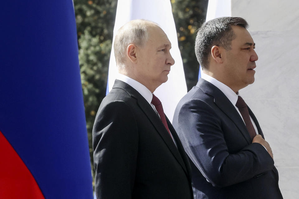 Russian President Vladimir Putin, left, and Kyrgyzstan's President Sadyr Japarov, right, attend a military welcome ceremony prior to their talks in Bishkek, Kyrgyzstan, Thursday, Oct. 12, 2023. (Sergei Karpukhin, Sputnik, Kremlin Pool Photo via AP)