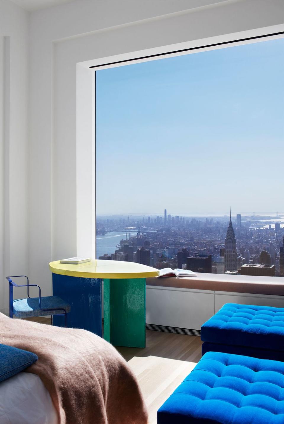 a room with a window and a table with a view of a city