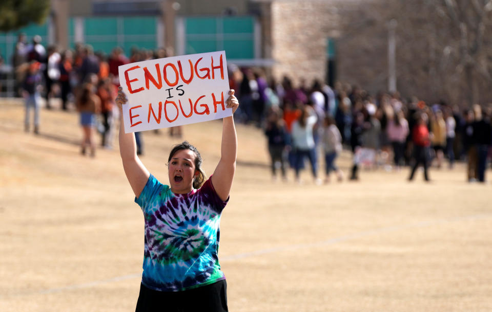 Columbine High School student Leah Zunder holds a sign.