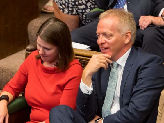 Phillip Lee dramatically crossed the floor to join Jo Swinson on the Liberal Democrat benches as Boris Johnson spoke in the Commons (EPA)