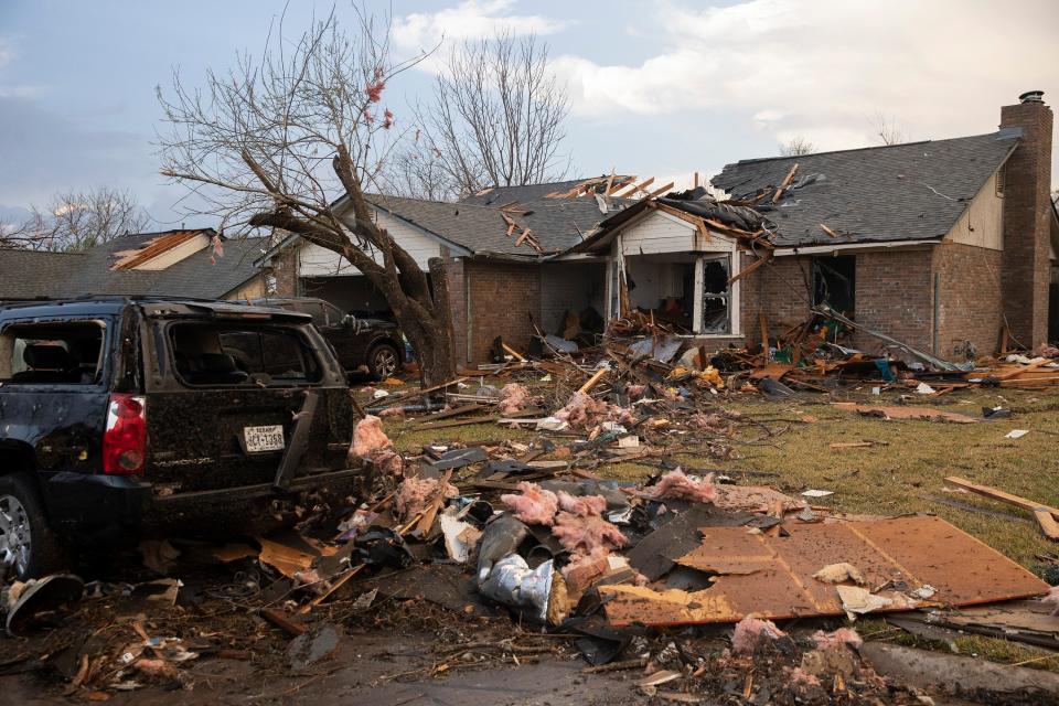 Debris litters the ground outside a house on Oxford Drive in Round Rock, Texas that was heavily damaged by a tornado (AP)