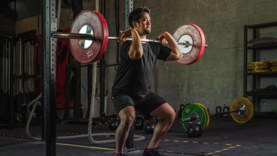 A man performing a barbell front squat