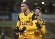 Wolverhampton Wanderers' Romain Saiss, left, celebrates with a teammate after scoring his sides 1st goal of the game during the English Premier League soccer match between Wolverhampton Wanderers and Tottenham Hotspur at Molineux Stadium, in Woverhampton, England, Sunday, Dec. 27, 2020. (Carl Recine/ Pool via AP)