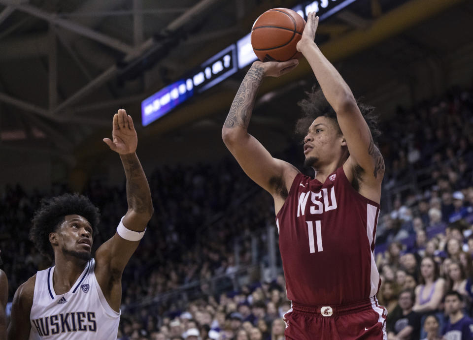 Washington State forward DJ Rodman shoots form 3-point range against Washington forward Keion Brooks Jr. during the second half of an NCAA college basketball game Thursday, March 2, 2023, in Seattle. Washington State won 93-84. (AP Photo/Stephen Brashear)