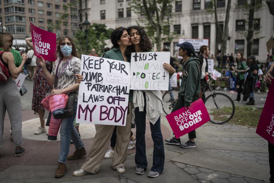 Rita Nakouzi, 46, and her daughter, Fairuz Nakouzi, 13, stand for a portrait during a protest in Manhattan on Saturday, May 14, 2022, in New York. More than 20 years ago, Nakouzi and her family came to the United States from Beirut with high expectations. But in recent years she has been disappointed - "what makes America what it is is being denigrated and broken down." She has joined many protests over the past 10 years. And now, abortion. (AP Photo/Wong Maye-E)