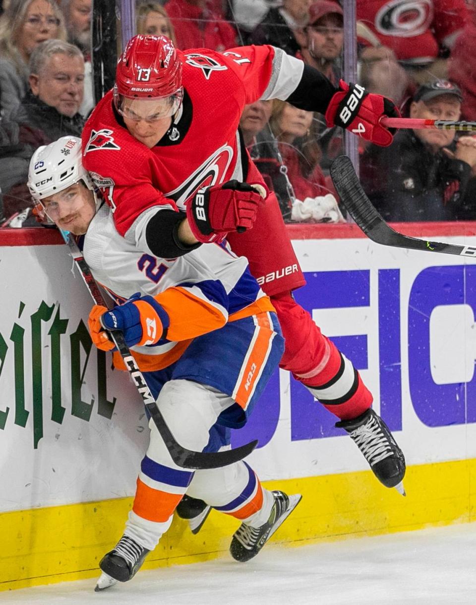 The Carolina Hurricanes Jesse Piljujarvi (13) checks the New York Islanders Sebastian Aho (25) in the first period during Game 5 of their Stanley Cup series on Tuesday, April 25, 2023 at PNC Arena in Raleigh, N.C.