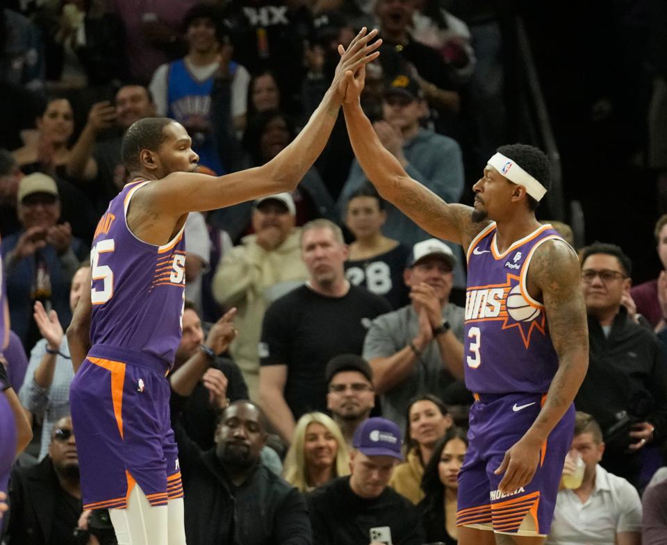 Phoenix Suns forward Kevin Durant (35) and guard Bradley Beal (3) celebrate a basket against the Oklahoma City Thunder during the first quarter at Footprint Center in Phoenix on March 3, 2024.
