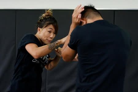 MMA fighter Angela Lee trains with her brother Christian Lee in Singapore May 18, 2017. REUTERS/Yong Teck Lim