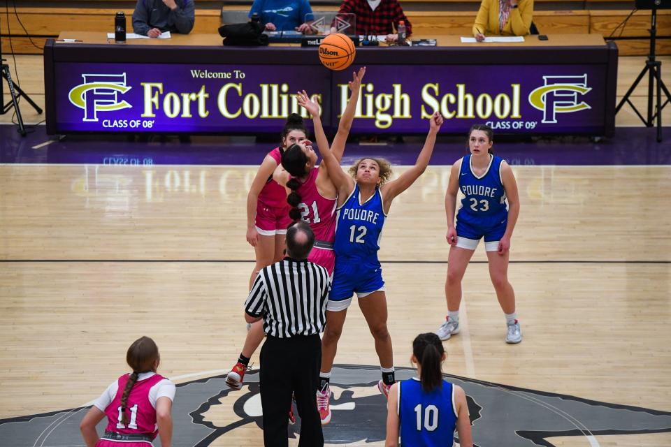 Poudre's Jaque Forrest (12) jumps for the opening tipoff against Rhya Cano (21) during a 2023 girls high school basketball game against Fort Collins.