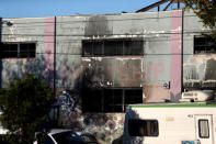 A charred wall is seen outside a warehouse after a fire broke out during an electronic dance party late Friday evening, resulting in at least nine deaths and many unaccounted for in the Fruitvale district of Oakland, California, U.S. December 3, 2016. REUTERS/Stephen Lam