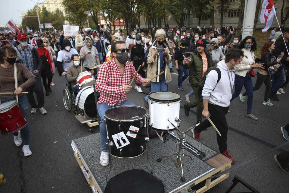 Protesters beat the drums during the opposition supporters rally protesting the official presidential election results in Minsk, Belarus, Sunday, Oct. 4, 2020. Hundreds of thousands of Belarusians have been protesting since the Aug. 9 presidential election. (AP Photo)