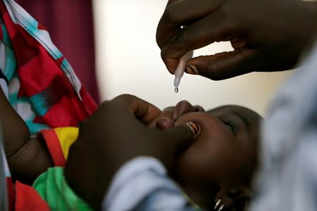 FILE PHOTO: A child is given a dose of polio vaccine at an immunisation health centre in Maiduguri, Borno State, Nigeria, in August 2016