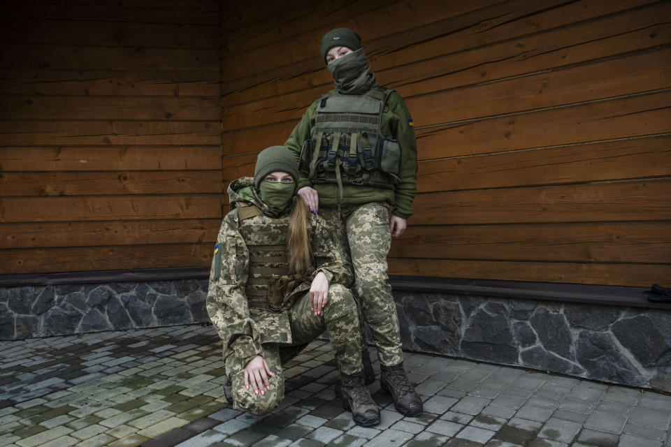 Territorial Defense of the Armed Forces, 21-year-olds Svitlana, right, and Myroslava, pose for a photograph, in Lviv, western Ukraine, Thursday, March 31, 2022. Both Svitlana, and Myroslava, who studied at the same university in Kyiv, decided to leave academia and serve their country by joining the TDF only one month ago. (AP Photo/Nariman El-Mofty)