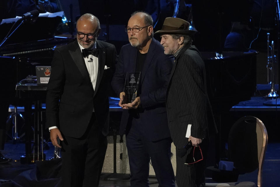 Manuel Abud, CEO of the Latin Recording Academy, left, and Joaquin Sabina, right, present Ruben Blades with the person of the year award at the Latin Recording Academy gala in his honor at the Mandalay Bay on Wednesday, Nov. 17, 2021, in Las Vegas. (AP Photo/Chris Pizzello)