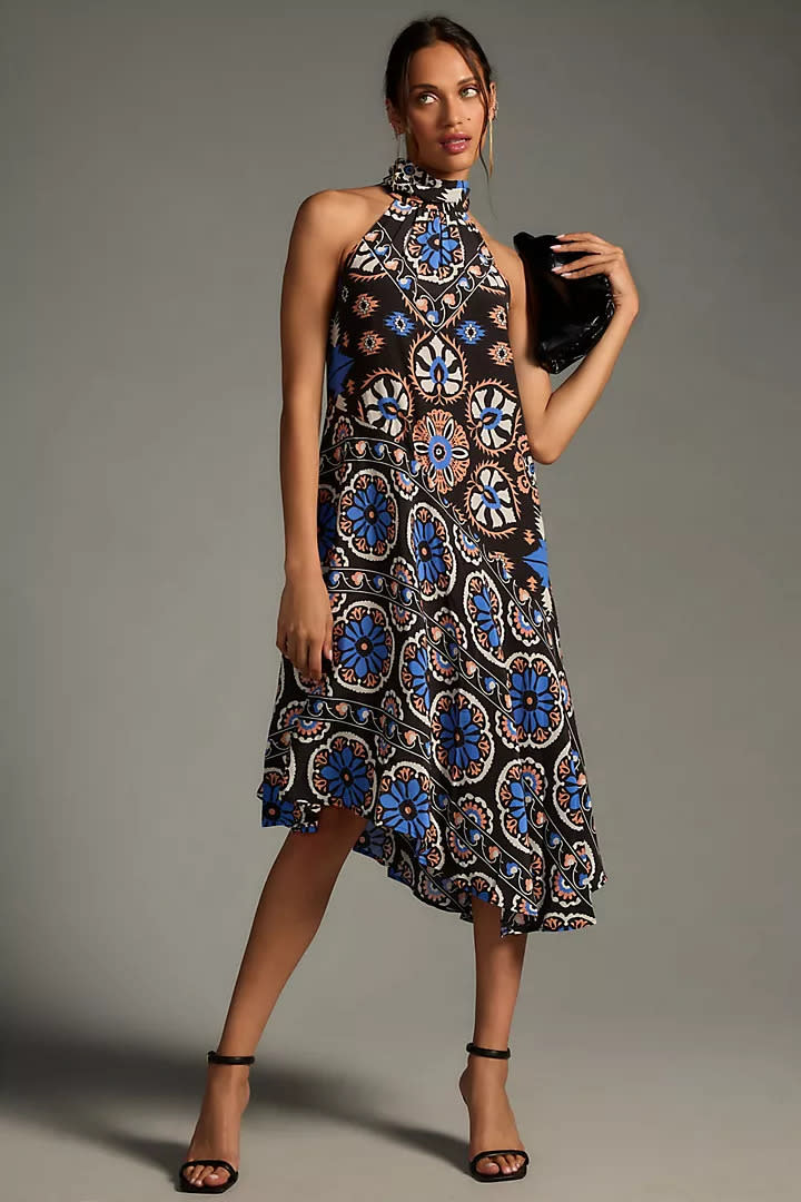 woman wears printed By Anthropologie Silk Halter Midi Dress.