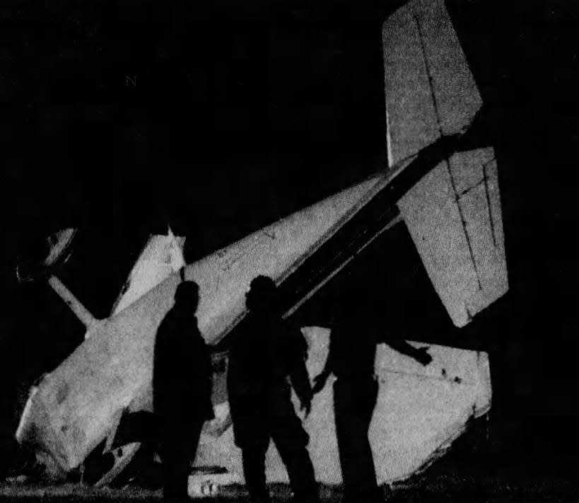 Emergency personnel examine wreckage at the crash scene in Veterans Memorial Park in Linden.