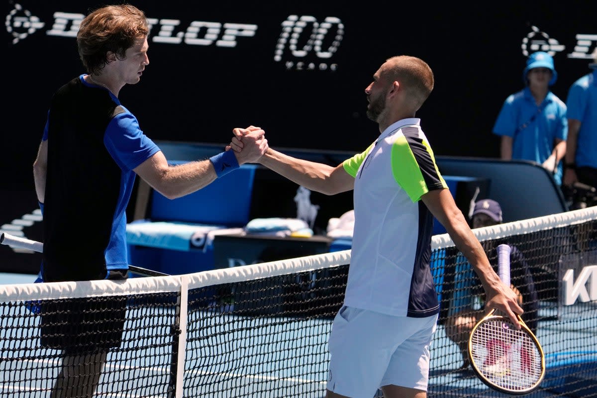 Dan Evans (right) congratulates Andrey Rublev (Ng Han Guan/AP) (AP)