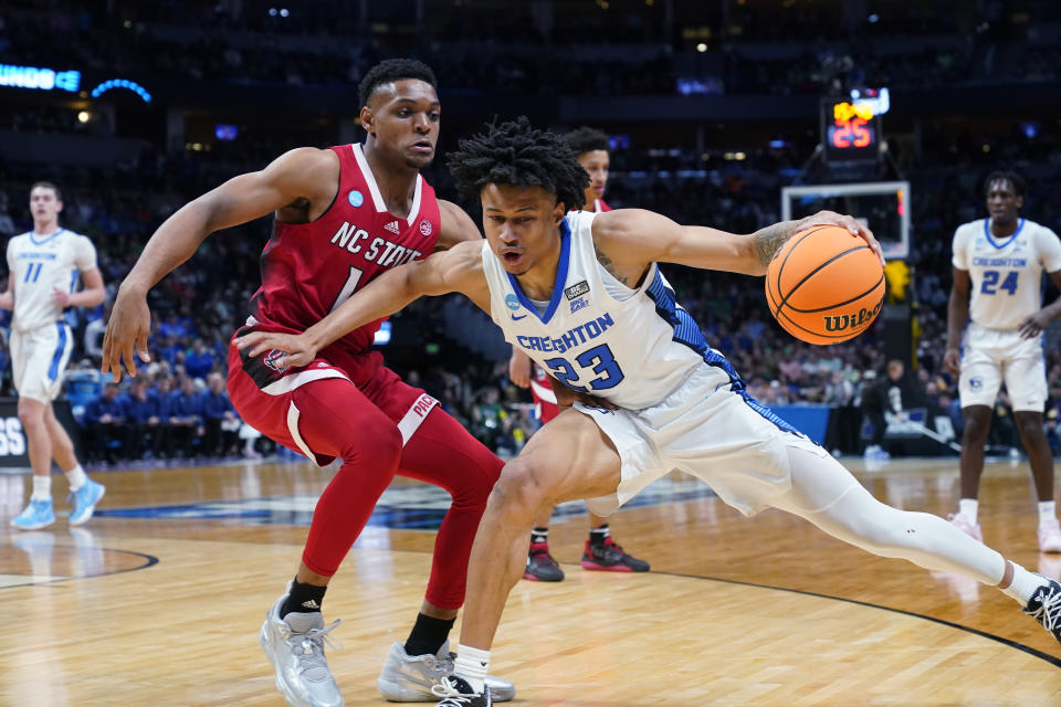 Creighton guard Trey Alexander, right, drives to the basket as North Carolina State guard Casey Morsell defends in the first half of a first-round college basketball game in the men's NCAA Tournament Friday, March 17, 2023, in Denver. (AP Photo/John Leyba)