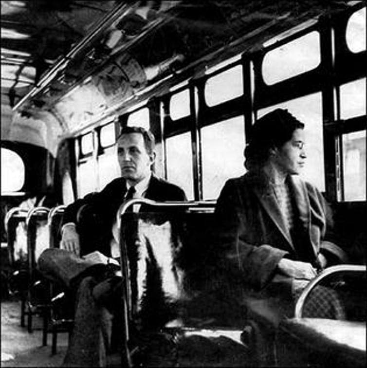 <span class="caption">Rosa Parks sits in the front of a bus in Montgomery, Alabama, in 1956 after the US Supreme Court ruled segregation illegal on the city’s bus system. Behind Parks is Nicholas C. Chriss, a UPI reporter covering the event.</span> <span class="attribution"><a class="link " href="https://www.loc.gov/rr/print/list/083_afr.html#ParksR" rel="nofollow noopener" target="_blank" data-ylk="slk:United Press photo;elm:context_link;itc:0;sec:content-canvas">United Press photo</a></span>