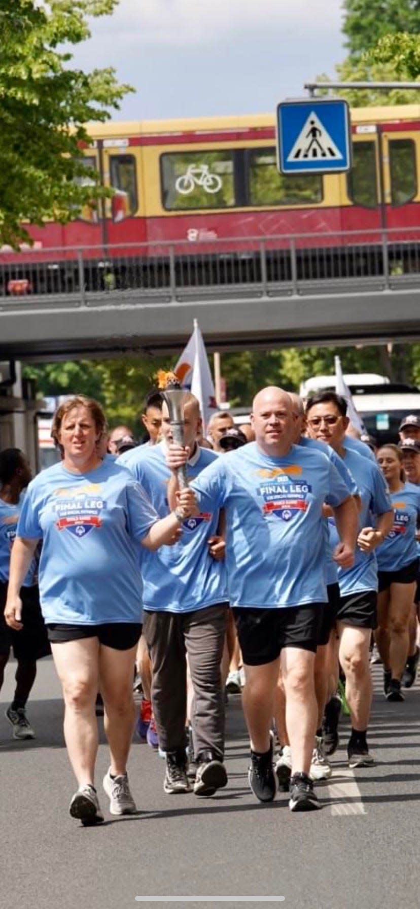 Harwich Deputy Police Chief Kevin Considine, right, running with athlete Stacey Hull in Berlin, Germany. Considine was one of 80 law enforcement officers from around the world to serve as guardians of the flame for the Special Olympics World Games 2023 Law Enforcement Torch Run Final Leg.