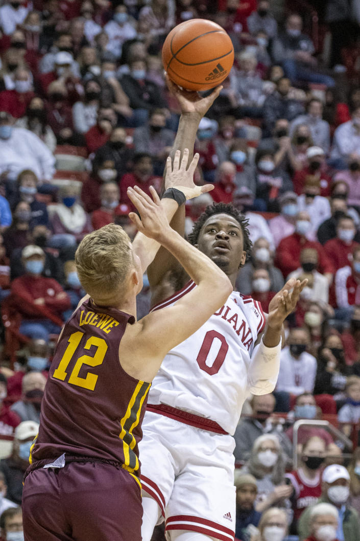Indiana guard Xavier Johnson (0) shoots over the defense of Minnesota guard Luke Loewe (12) during the second half of an NCAA college basketball game, Sunday, Jan. 9, 2022, in Bloomington, Ind. (AP Photo/Doug McSchooler)