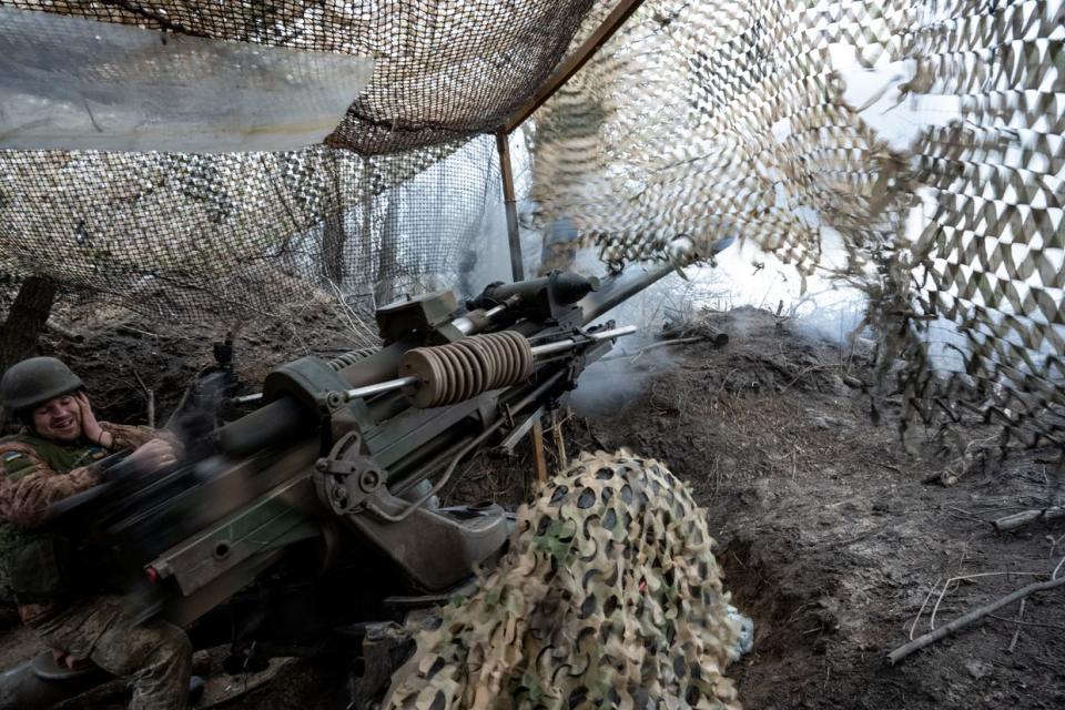 Soldiers of the Ukraine Army's 95th Brigade fire 105mm artillery shells from a British-made M119 howitzer at Russian positions in the Lyman direction on Feb. 18, 2024. (Scott Peterson/Getty Images)