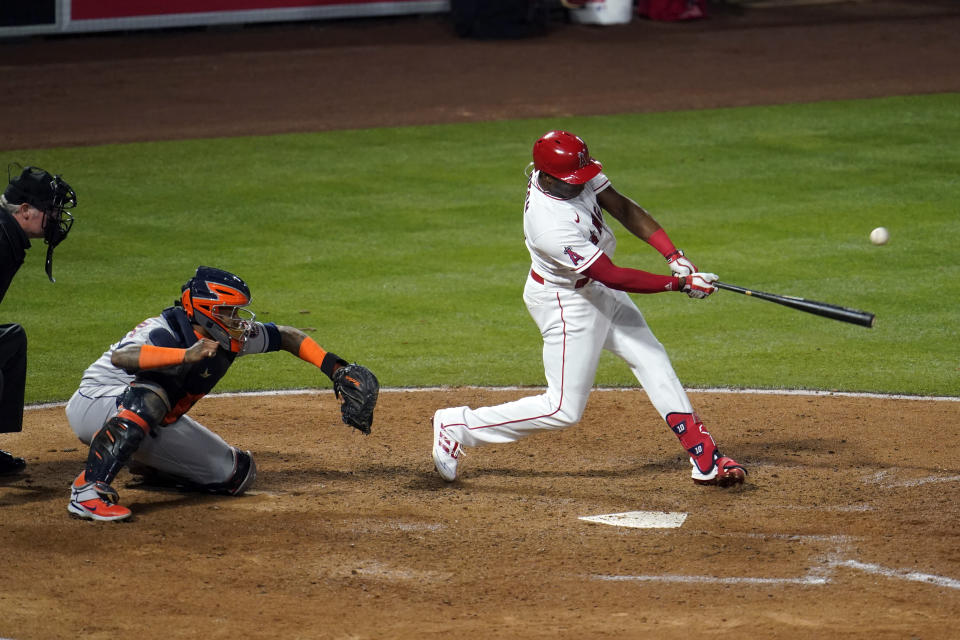 Los Angeles Angels' Justin Upton drives in a run with a single during the fifth inning of a baseball game against the Houston Astros, Monday, April 5, 2021, in Anaheim, Calif. (AP Photo/Marcio Jose Sanchez)