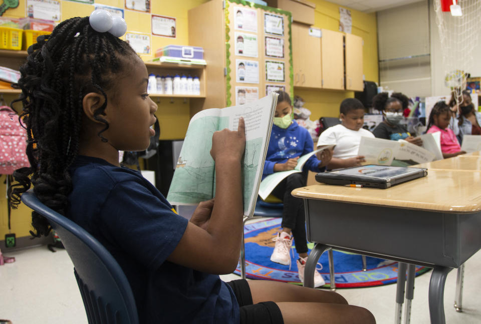 FILE - A third-grade student reads to the rest of her class at Beecher Hills Elementary School on Aug. 19, 2022, in Atlanta. For decades, there has been a clash between two schools of thought on how to best teach children to read, with passionate backers on each side of the so-called reading wars. But the approach gaining momentum lately in American classrooms is the so-called science of reading. (AP Photo/Ron Harris, File)