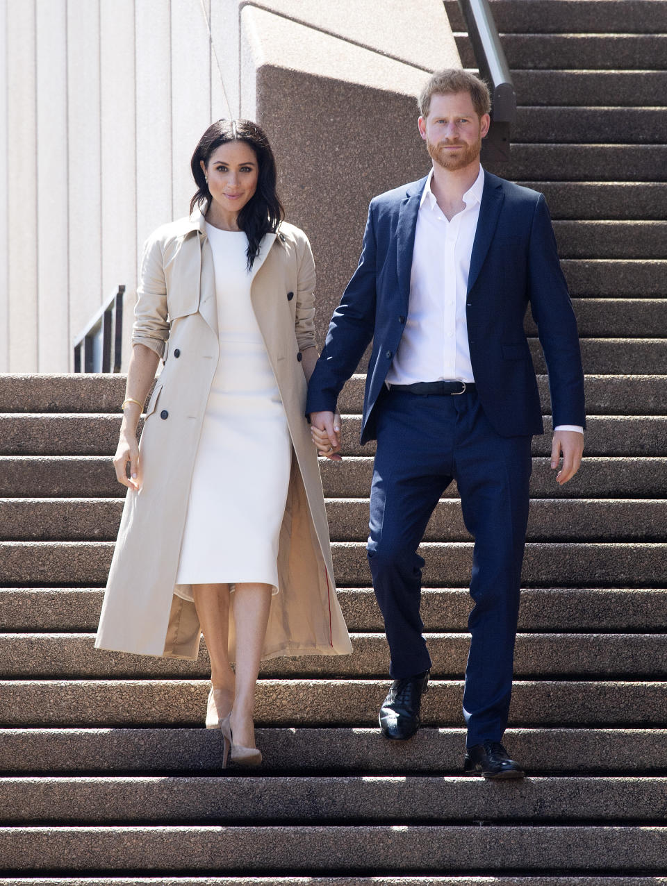 Meghan wearing a trench coat at the Sydney Opera House on October 16, 2018 [Photo: Getty]