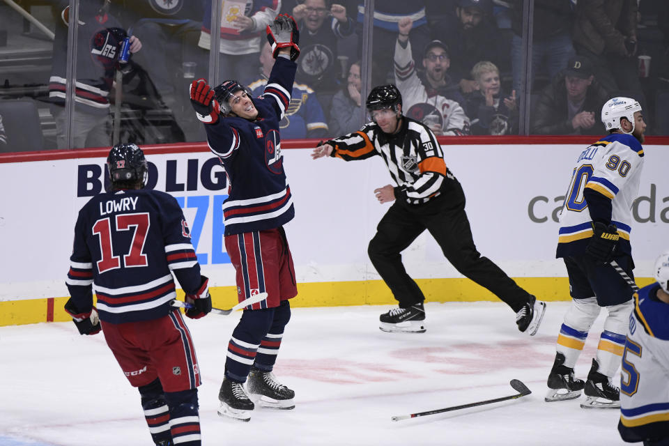 Winnipeg Jets' Morgan Barron (36) celebrates after his goal against the St. Louis Blues with teammate Adam Lowry (17) during the third period of NHL hockey game action in Winnipeg, Manitoba, Monday, Oct. 24, 2022. (Fred Greenslade/The Canadian Press via AP)