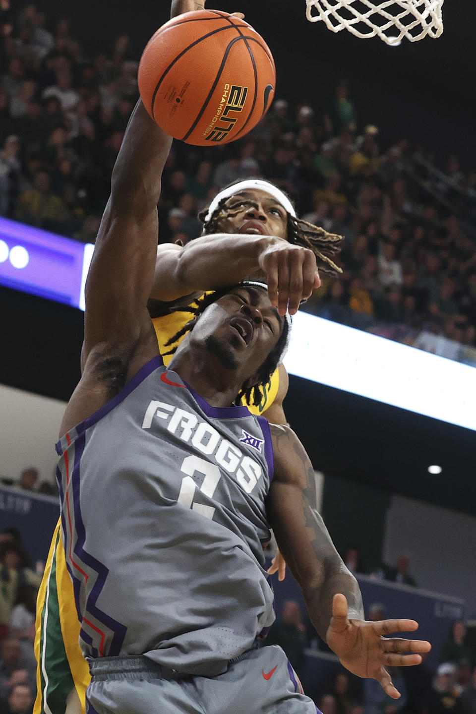 Baylor guard Jayden Nunn (2) fouls TCU forward Emanuel Miller (2) as he attempts to score during the second half of an NCAA college basketball game Saturday, Jan. 27, 2024, in Waco, Texas. (AP Photo/Jerry Larson)