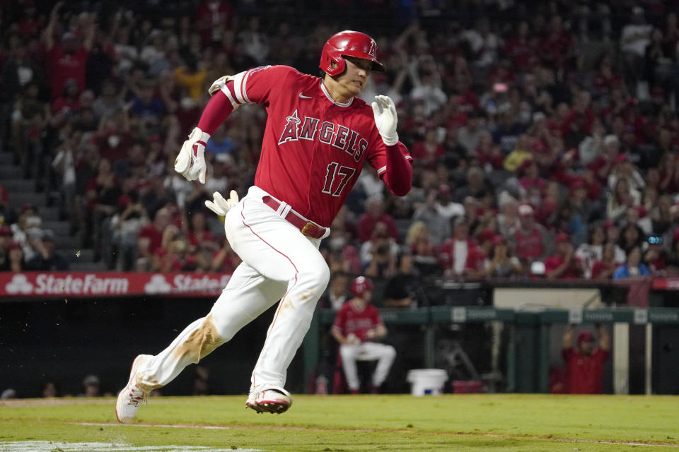 Los Angeles Angels designated hitter Shohei Ohtani rounds first on his way to a triple during the third inning of a baseball game against the Seattle Mariners Saturday, Sept. 25, 2021, in Anaheim, Calif. (AP Photo/Mark J. Terrill)