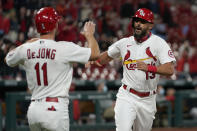 St. Louis Cardinals' Matt Carpenter (13) is congratulated by teammate Paul DeJong (11) after hitting a two-run home run during the third inning of a baseball game against the Washington Nationals Tuesday, April 13, 2021, in St. Louis. (AP Photo/Jeff Roberson)