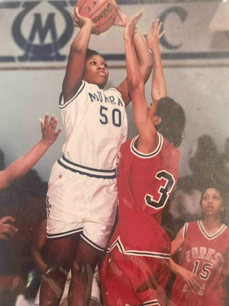 Tomekia Reed rises over a defender in high school. Charlotte 49ers’ current coach was part of a team that won three 5A state championships in Mississippi and was nationally ranked.