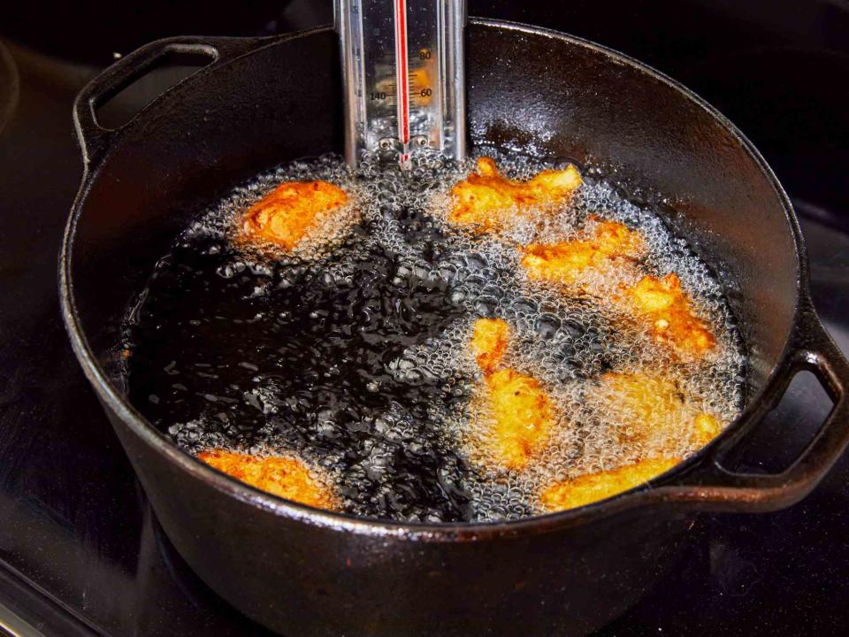 frying hush puppies in a cast iron skillet