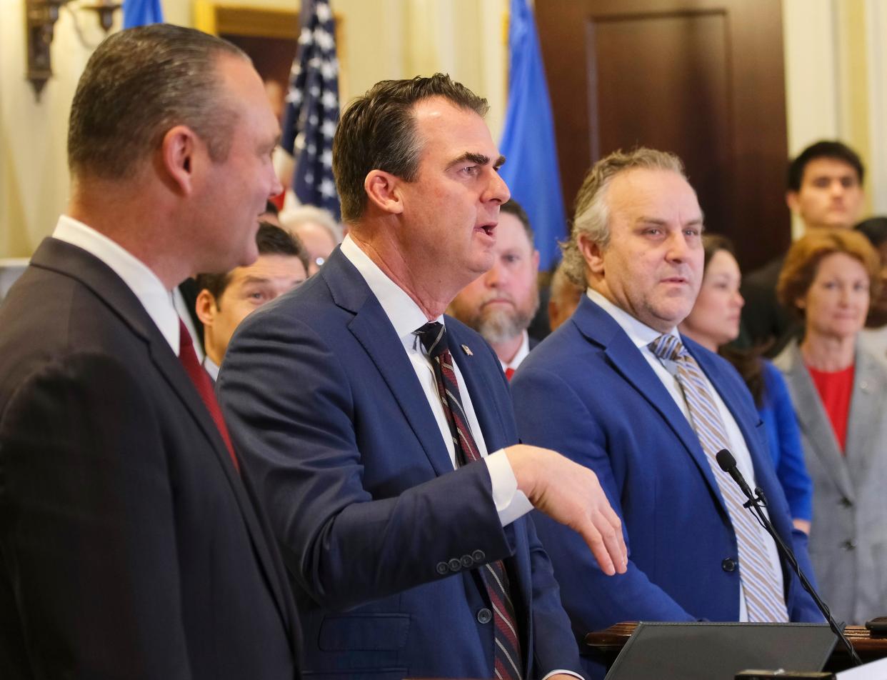 Gov. Kevin Stitt, middle, is flanked by House Speaker Charles McCall, left and Senate Pro Tempore Greg Treat during a recent event at the state Capitol.