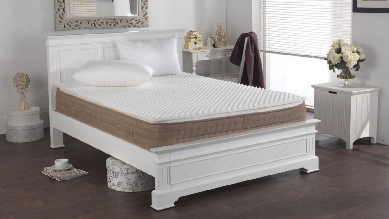  Egg crate mattress topper on bed in styled room  